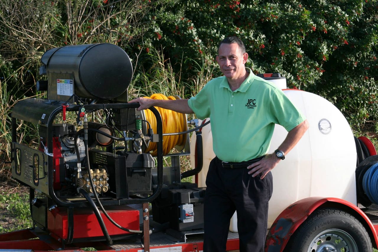 Jacobs Pressure Cleaning owner standing with pressure washing equipment